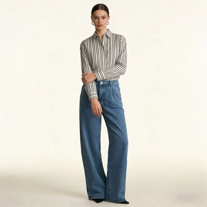 Professional full body shot of high waist wide leg jeans paired with a striped shirt