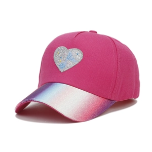 Detail of pink kids baseball cap featuring a glitter heart and rainbow sequin brim