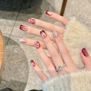 Handmade burgundy cat eye press-on nails with gold glitter and shell accents