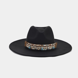 Detail of black wool fedora with ethnic woven band and sea star charm pendant