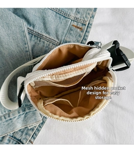 Interior detail of white crossbody bag featuring mesh pockets for organized storage