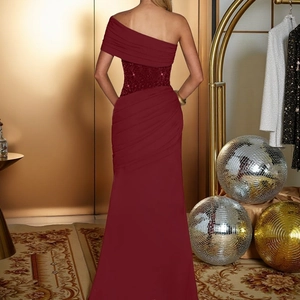 Detail view of the sequined waist and elegant pleated back of the burgundy ball gown