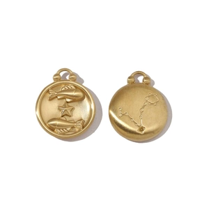 Detail of matte 18k gold Pisces zodiac charms showing embossed star constellation