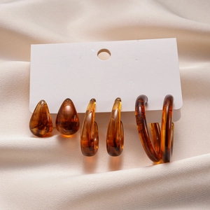 Detailed set of acrylic drop and round earrings with amber tortoiseshell patterns
