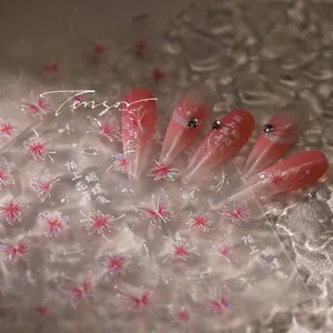 Macro shot of M-511 nail art stickers featuring pink butterfly and floral patterns
