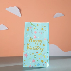 Light blue kraft paper birthday gift bag with colorful balloons and gold glitter lettering