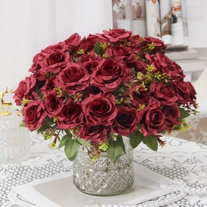 Elegant red artificial roses in a diamond-cut glass vase for home and wedding decor