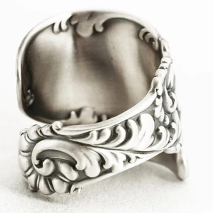 Macro shot of vintage silver open ring with intricate classical acanthus leaf relief patterns