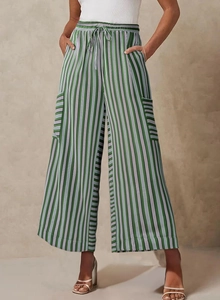 Close-up of green and white striped wide-leg trousers with drawstring elastic waist