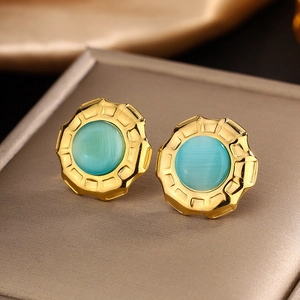 Macro detail of 18K gold-plated stud earrings with turquoise stone and crystal inlay