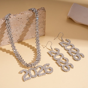 Detail of silver 2026 number pendant necklace and earrings set with rhinestones