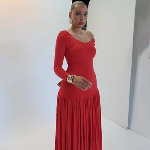 Detail view of red one-shoulder long sleeve dress with ruched slit and elegant draping
