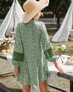 Green floral dress with lace patchwork sleeves shown in a lush garden picnic setting