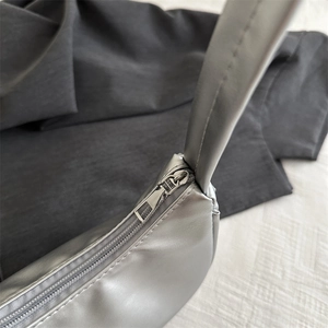 Chic silver metallic moon bag with zipper detail and minimalist shoulder strap design