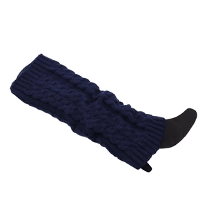 Detailed view of dark blue cable knit leg warmers with thick winter texture patterns