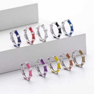 Macro shot of bamboo-style colorful enamel hoop earrings in sterling silver finish