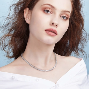 Close-up of 4mm S925 sterling silver tennis chain necklace with clear cubic zirconia on a model