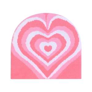 Pink knitted beanie with layered heart patterns for winter warmth and fashion