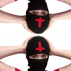 Close-up of handmade knitted balaclava featuring red crochet cross patterns on black wool