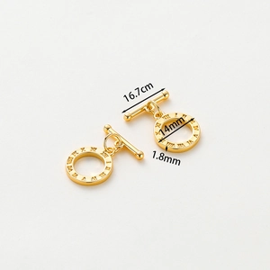 Macro detail of 14k gold plated OT toggle clasp with Roman numeral engravings and dimensions