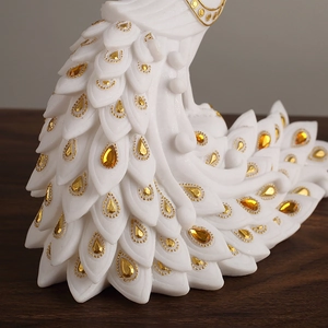 Elegant white resin peacock statue with gold accents and amber gems for home decor