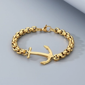 Macro detail of men's gold 18k plated anchor pendant on a heavy stainless steel box chain