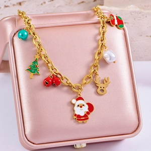 Close-up of gold holiday bracelet with Santa Claus, reindeer and Christmas tree charms