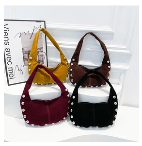 Detailed display of four vintage hobo bags with silver studs in various colors