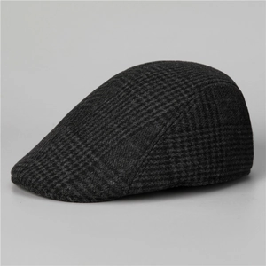 Side view of dark grey houndstooth wool flat cap showing fabric texture and contour