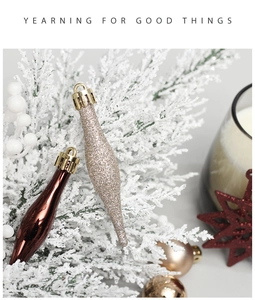 Close-up of champagne gold glitter and dark brown teardrop Christmas ornaments in festive decor