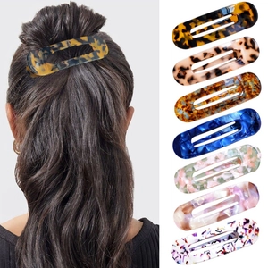 Detail of 7-piece acetate hair clip set in various marble patterns for half-up hairstyles