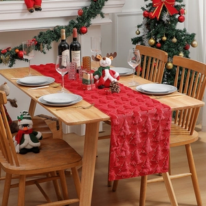Red Christmas table runner with 3D embroidered trees on a festive dining table