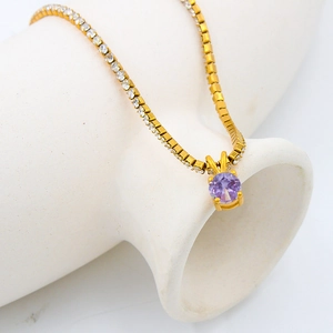 Gold birthstone necklace with purple zircon pendant and crystal pavé tennis chain