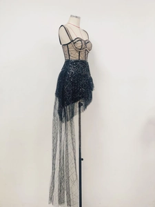 Detail of black sequined mini dress with sheer mesh overlay and sleek bodice design