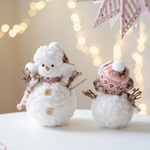 Plush Christmas snowman dolls set with pink knit hats and scarves on festive background