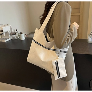 Detail of white pleated tote bag with black zipper and small matching coin purse pouch