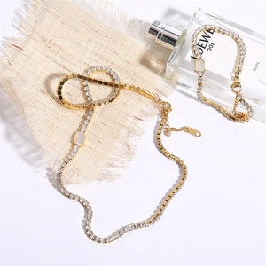 Detail of 18K gold-plated stainless steel tennis jewelry set with emerald-cut white stones