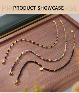 Detail of bohemian handmade beaded anklets with 18k gold plating and stone accents