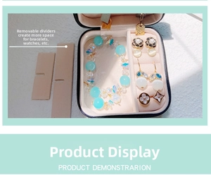 Macro shot of portable jewelry box showing internal partitions with rings and earrings