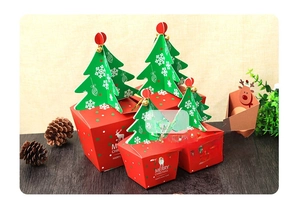 Three sizes of red Christmas gift boxes with 3D green tree lids and reindeer patterns
