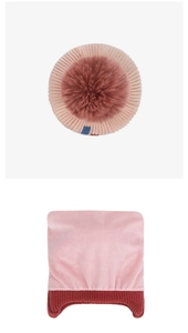 Detail of baby winter knit hat featuring warm pink plush lining and faux fur pompom