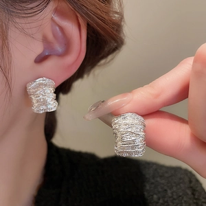 Minimalist silver U-shaped earrings with irregular texture and cubic zirconia accents