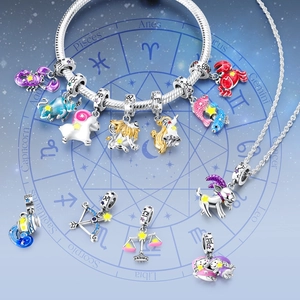 Luminous 925 silver zodiac charms on a celestial blue astrological compass background