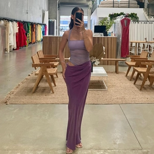 Detail view of purple satin maxi skirt with side cut-out and halter neck design