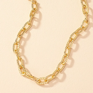 Hip hop style gold textured link chain necklace for men and women on pink background