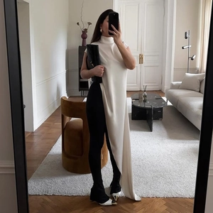 Elegant white satin sleeveless top with high neck and asymmetrical drape design