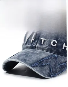 Macro view of blue washed denim baseball cap featuring white 3D embroidery and stitching