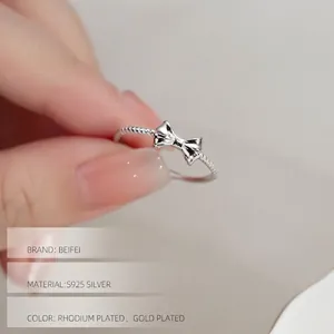 Elegant S925 sterling silver bow ring with twisted band, available in gold and silver