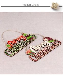 Detail showing two Merry Christmas wooden plaques with festive red and green plaid patterns