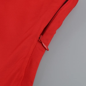 Close-up of red ruffled dress detail with high-quality invisible zipper and twill fabric